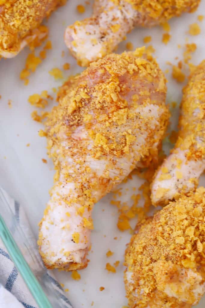 raw chicken drumsticks with cornflake coating, baked chicken with corn flakes, chicken with corn flakes. 