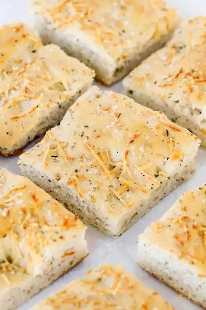 herb focaccia bread cut up into squares to be served, a great bread recipe. italian herb bread.