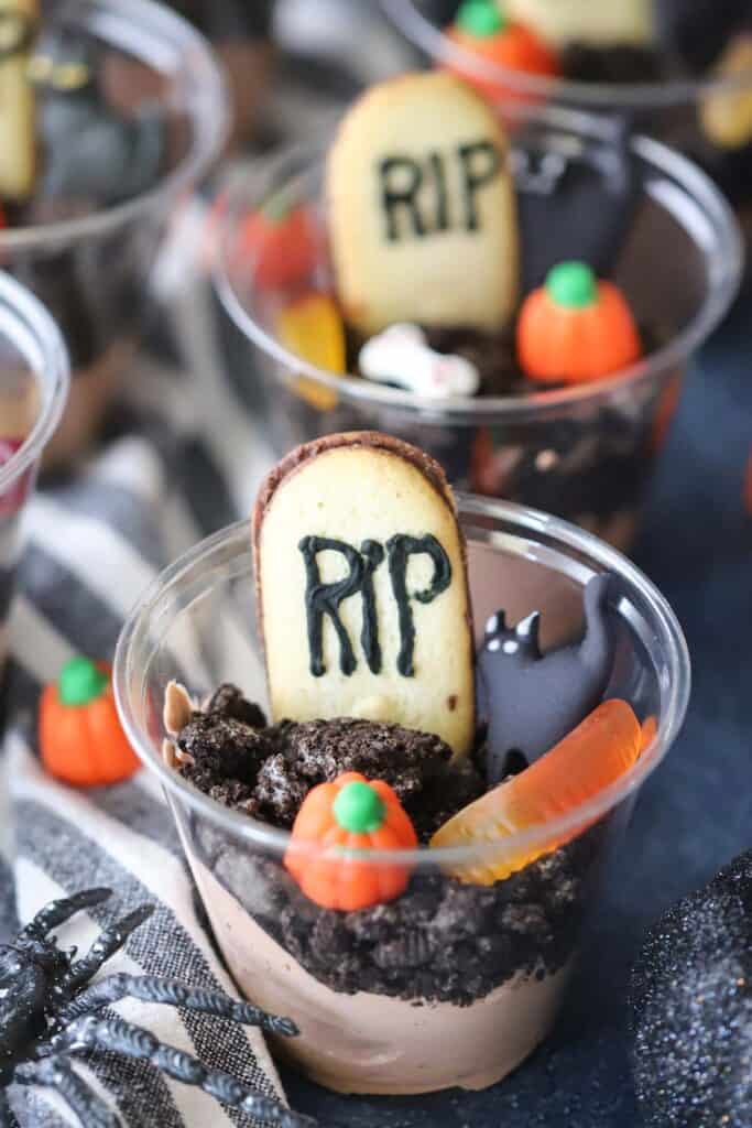 Halloween pudding cups, decorated to look like graveyard pudding. Dirt cups halloween desserts are great for parties.