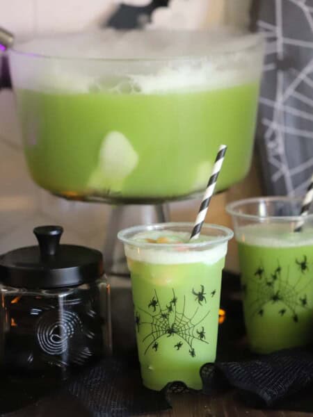 Green Witch Punch on a table decorated for halloween
