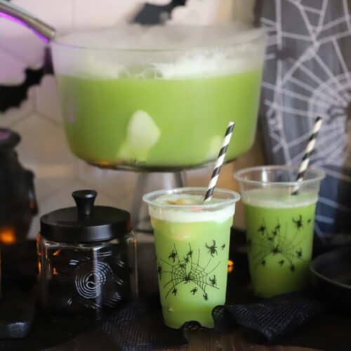 Green Witch Punch on a table decorated for halloween