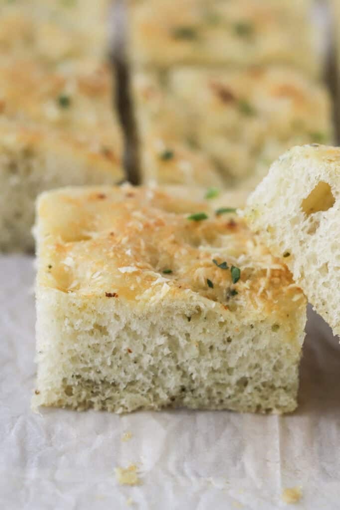 herb focaccia bread stacked in a pile on a plate.