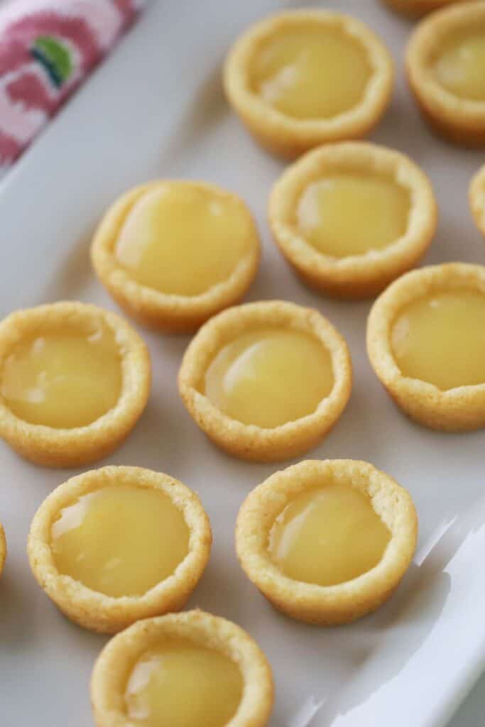 lemon cookie cups on a white serving platter. 