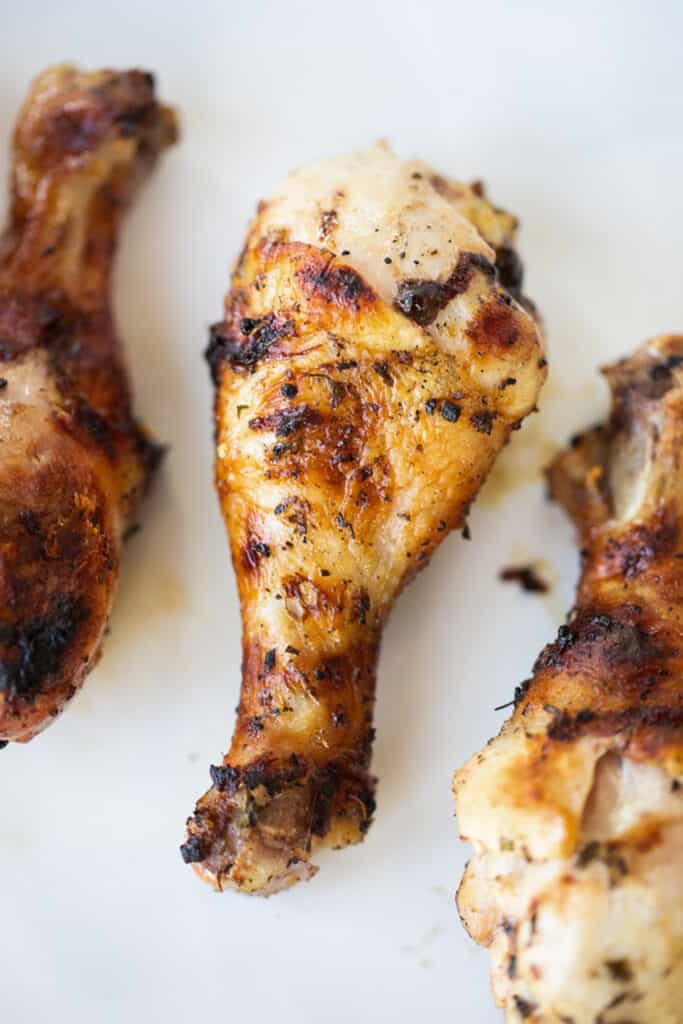 Grilled chicken drumsticks on a countertop made with our mediterranean chicken drumsticks marinade for grilling.