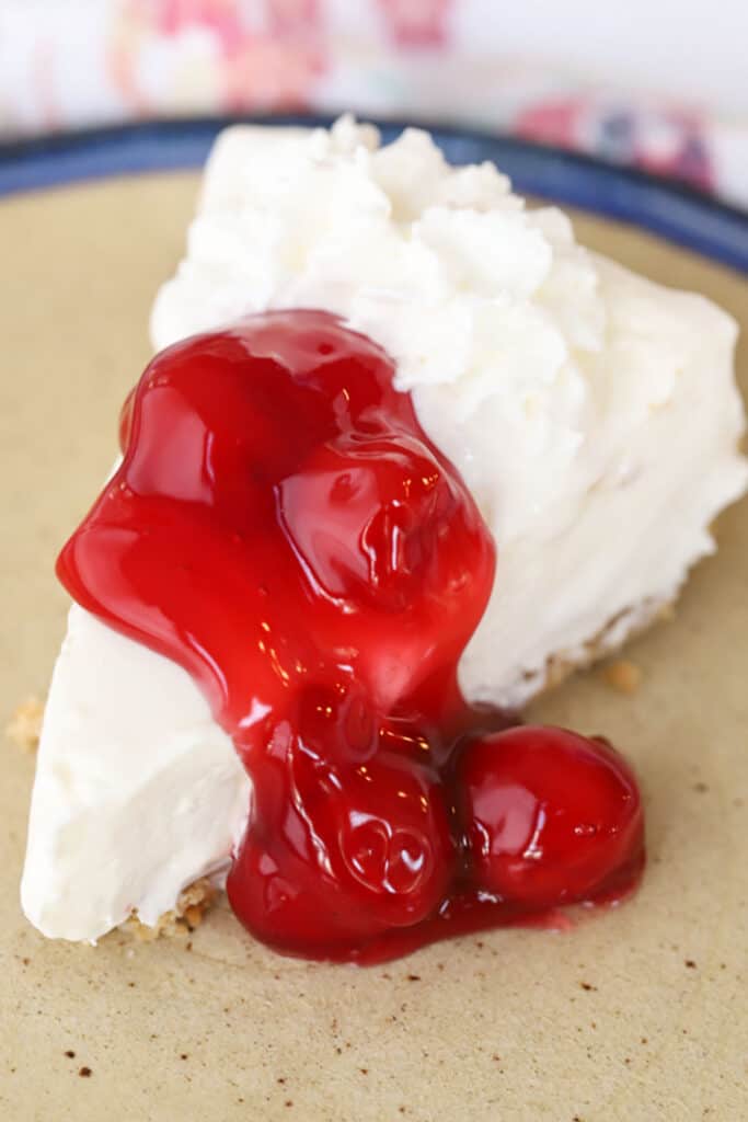 classic no bake Cheesecake recipe with graham cracker crust, topped with cherry pie filling.
