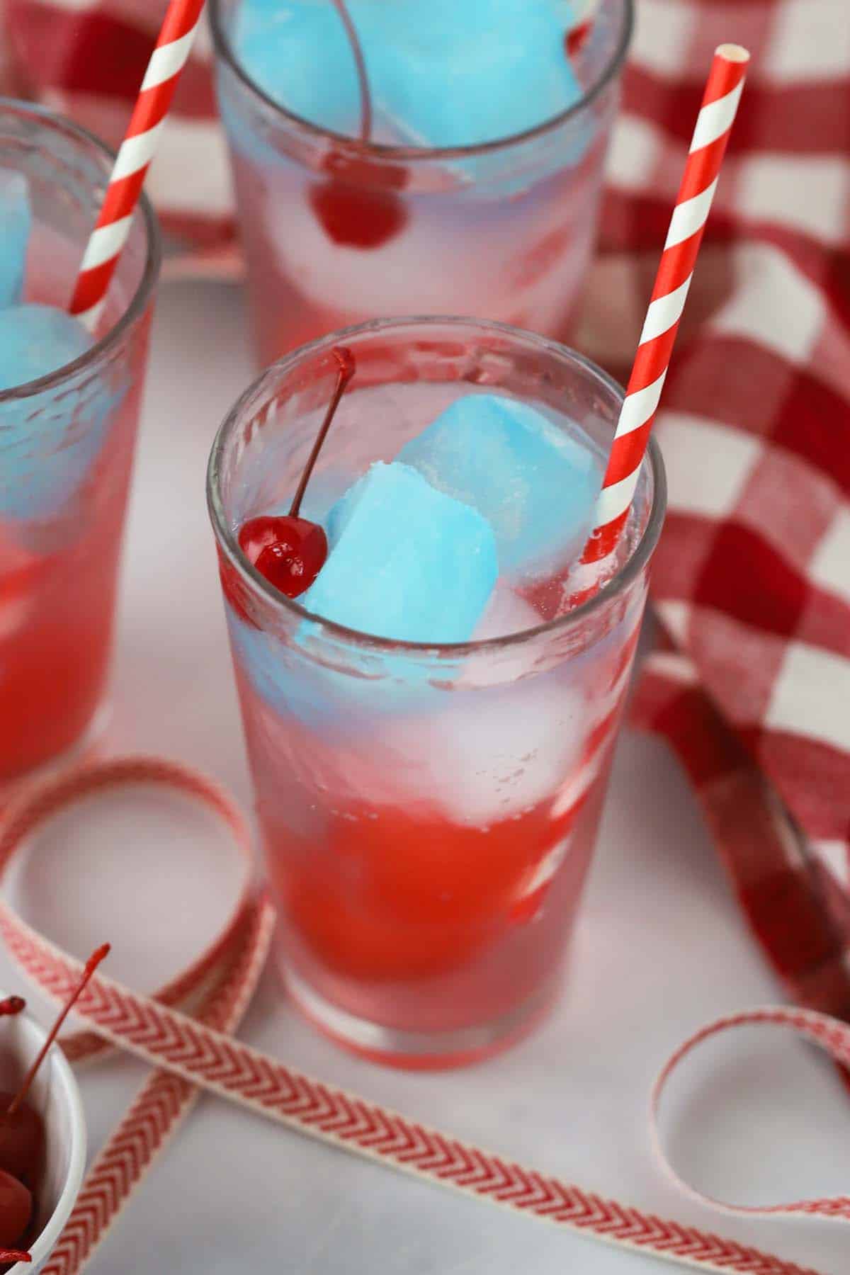 Patriotic Zeal 5 A tall glass full of Sprite with red white and blue gatorade ice cubes and a colorful straw. It's perfectly layered and ready to drink.
