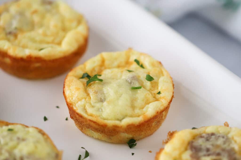 easy cottage cheese egg bites, an easy high protein bites recipe full of spinach and sausage.