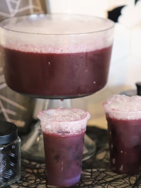 purple witch punch on a table decorated for halloween