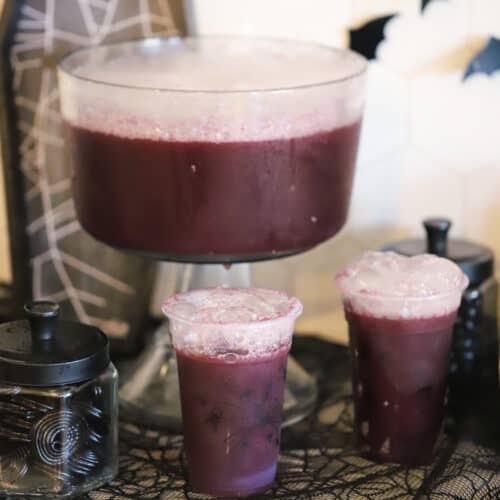 purple witch punch on a table decorated for halloween