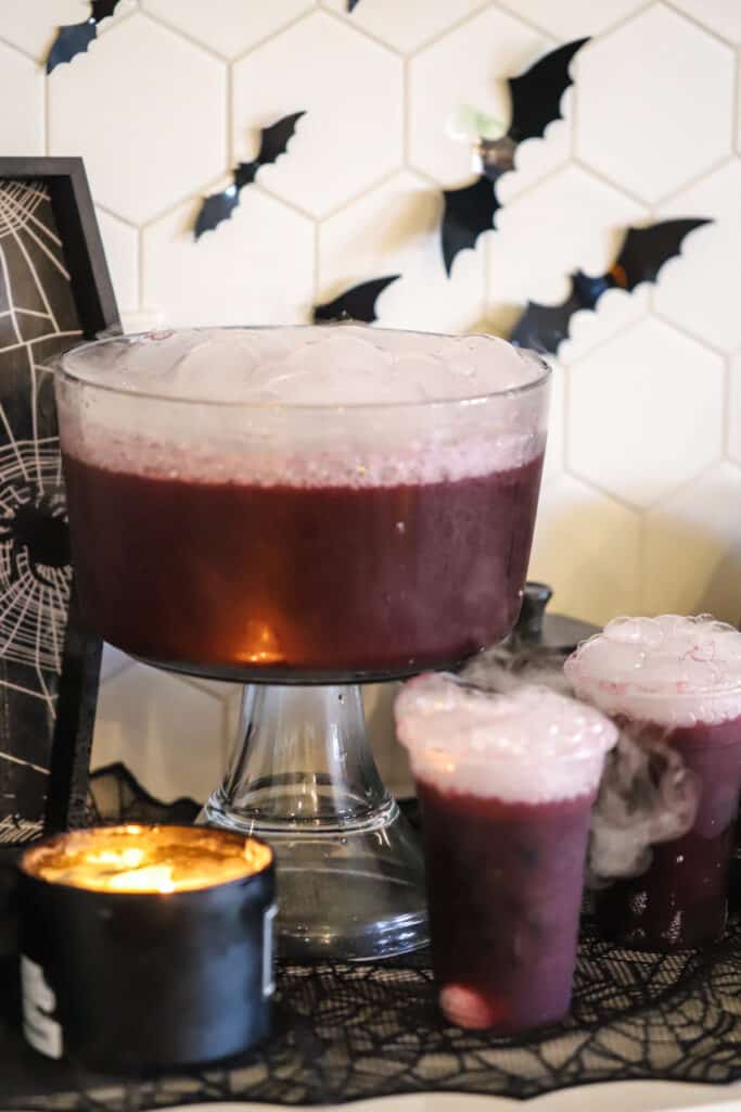 A large punch bowl full of purple Halloween punch for kids, it's a non-alcoholic Halloween punch with just 4 ingredients.