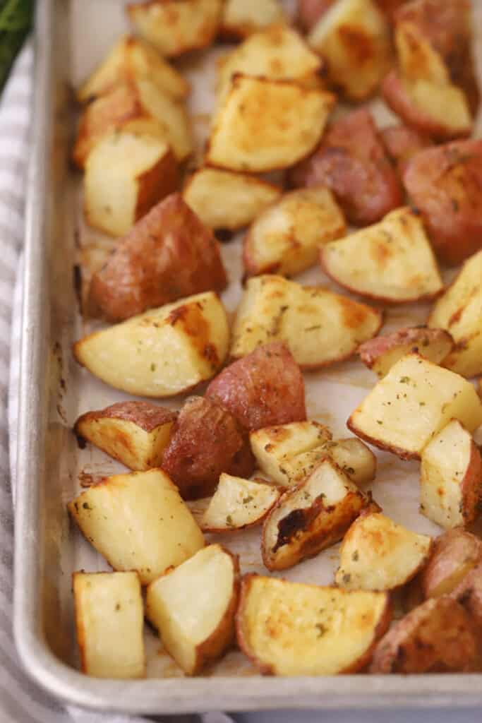 crispy Roasted Ranch potatoes on a sheet tray, crispy ranch potatoes in the oven, ranch roasted potatoes, ranch potatoes in oven. 