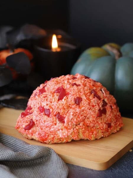 A halloween decorated table with a rice krispies brain.