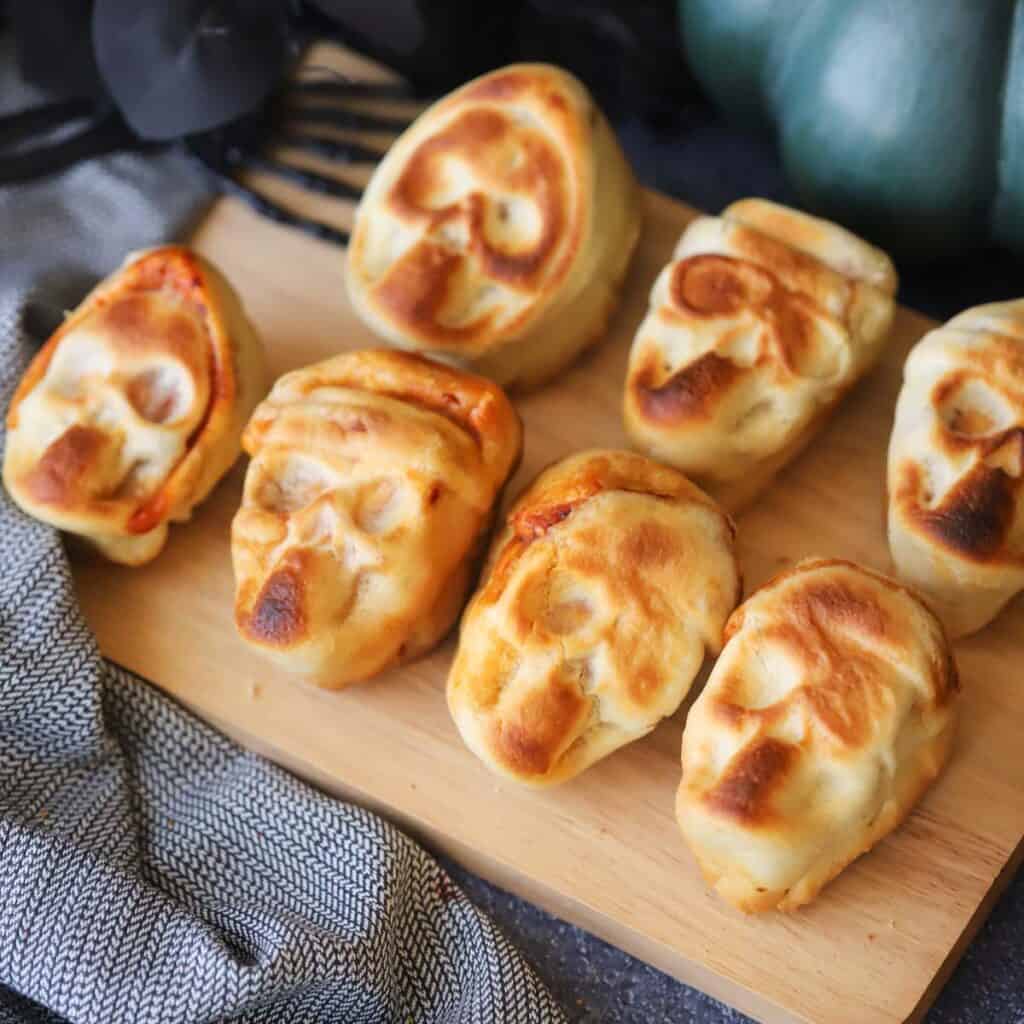 halloween pizza skulls on a serving plate.