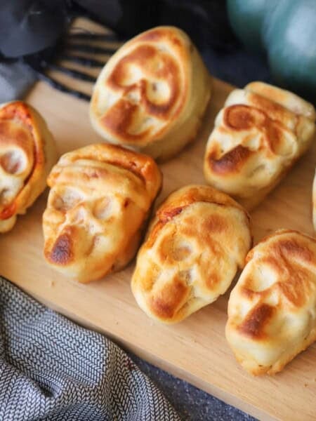 halloween pizza skulls on a serving plate.