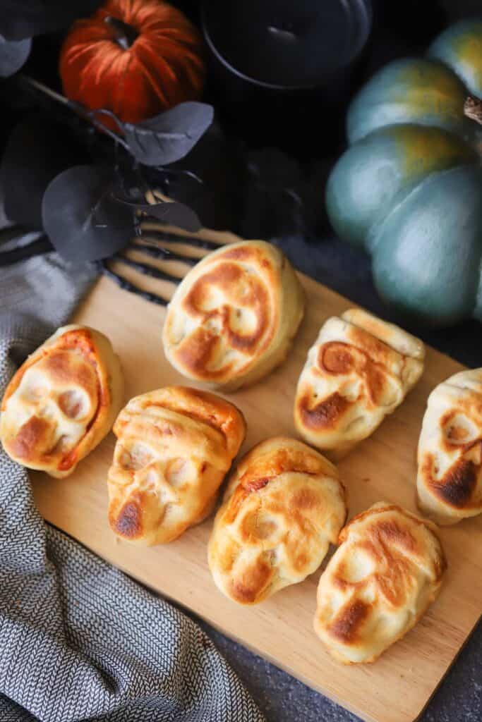 Halloween Pizza Skulls on a cutting board, the perfect pizza pockets for halloween parties.