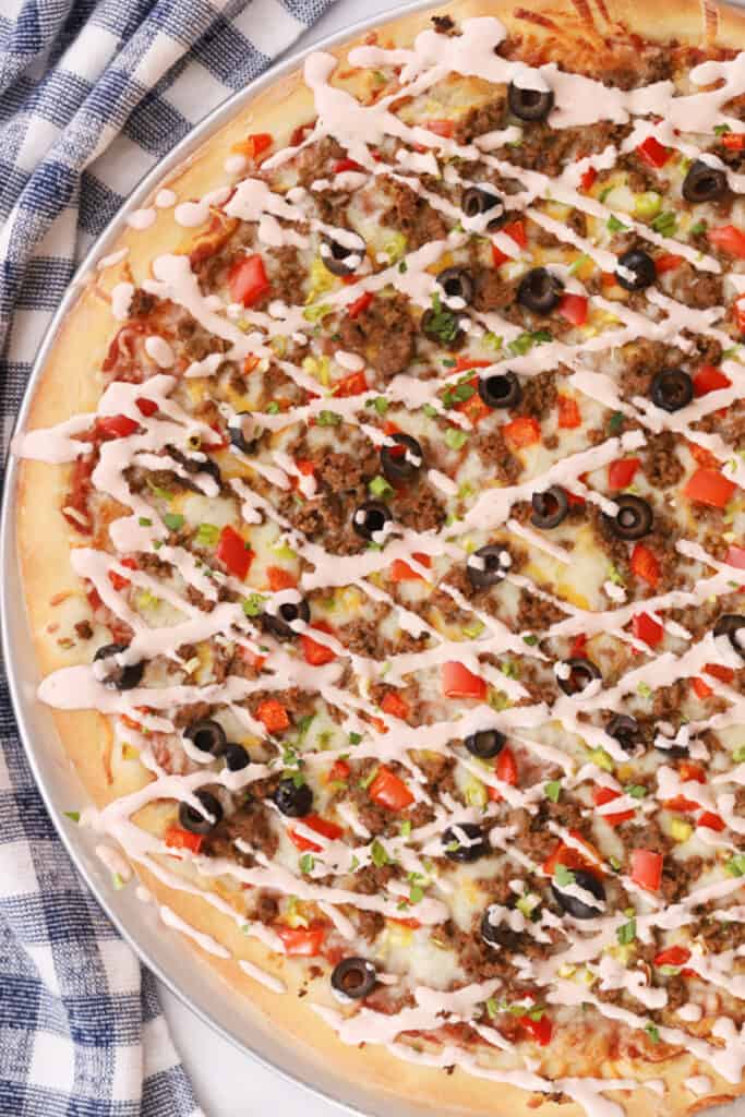 easy taco pizza, baked with a salsa ranch drizzle
