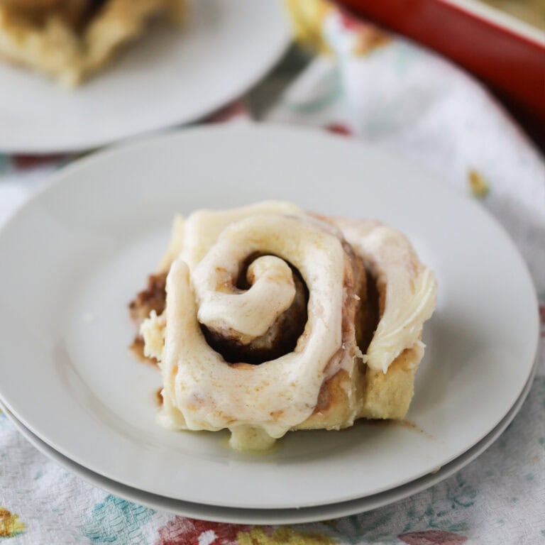 cinnamon rolls rising in a baking dish, best cinnamon roll recipe, best homemade cinnamon rolls.