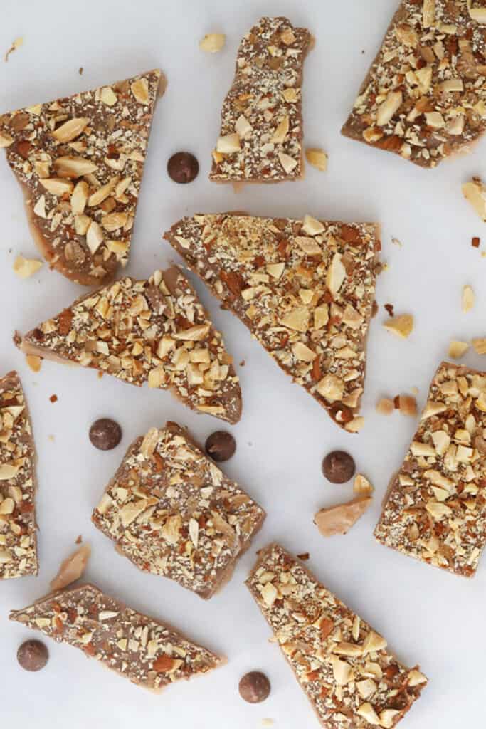 Butter toffee broken into pieces on a countertop, a delicious buttery toffee recipe.