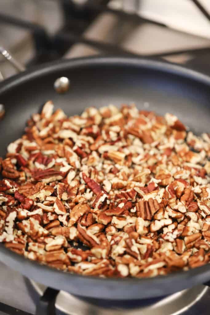 Toasting pecans in a skillet in order to make German chocolate topping for cake, brownies, and cupcakes.