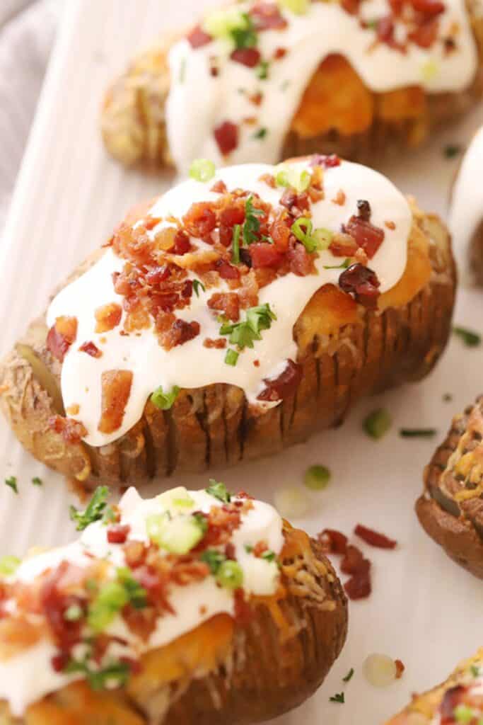 cheesy Hasselback Potatoes fully loaded with sour cream, green onions, and bacon bits, hasselback potatoes recipe. What to serve with hasselback potatoes.