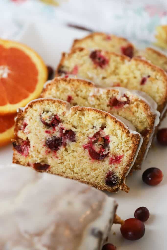 Orange Cranberry Bread sliced and topped with orange glaze, an easy quick bread recipe for the holidays.