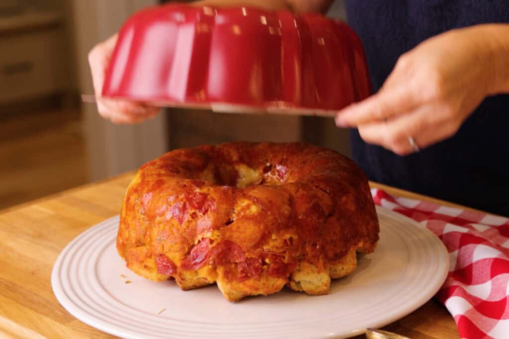 pizza monkey bread coming out of a bundt cake pan with cheesy crust. 