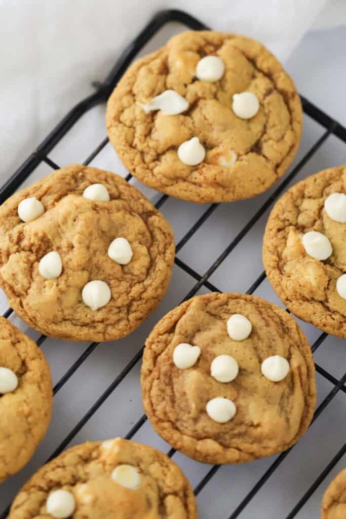 how to make Pumpkin Cookies with White Chocolate Chips, the white chocolate chip pumpkin cookies are cooling on a wire rack.