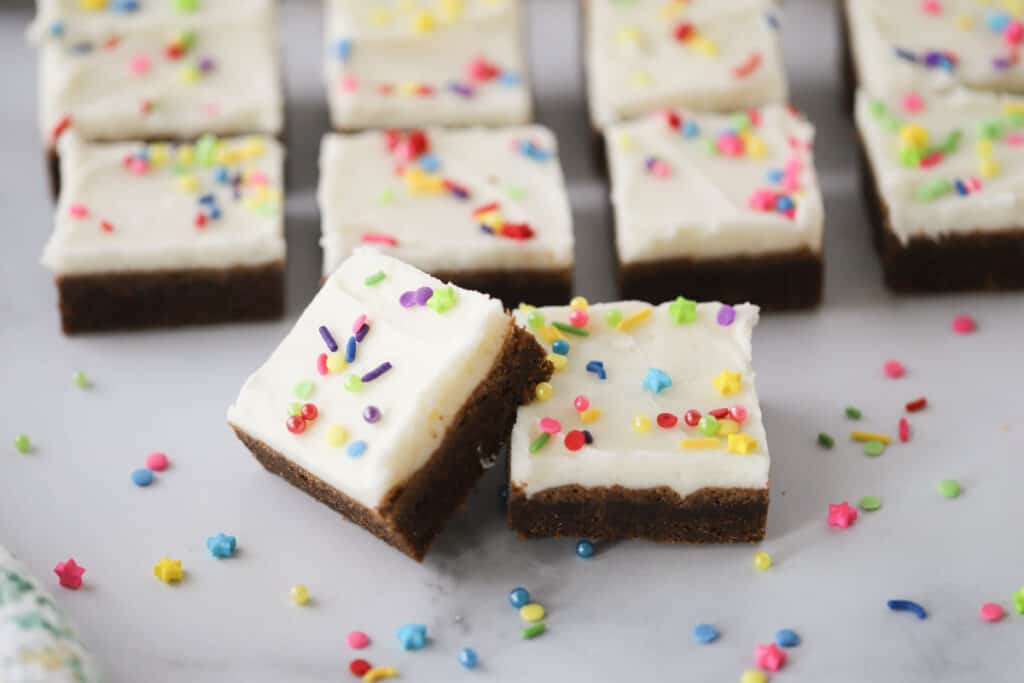 Chewy chocolate sugar cookie bars frosted with vanilla buttercream, chocolate cookie squares.