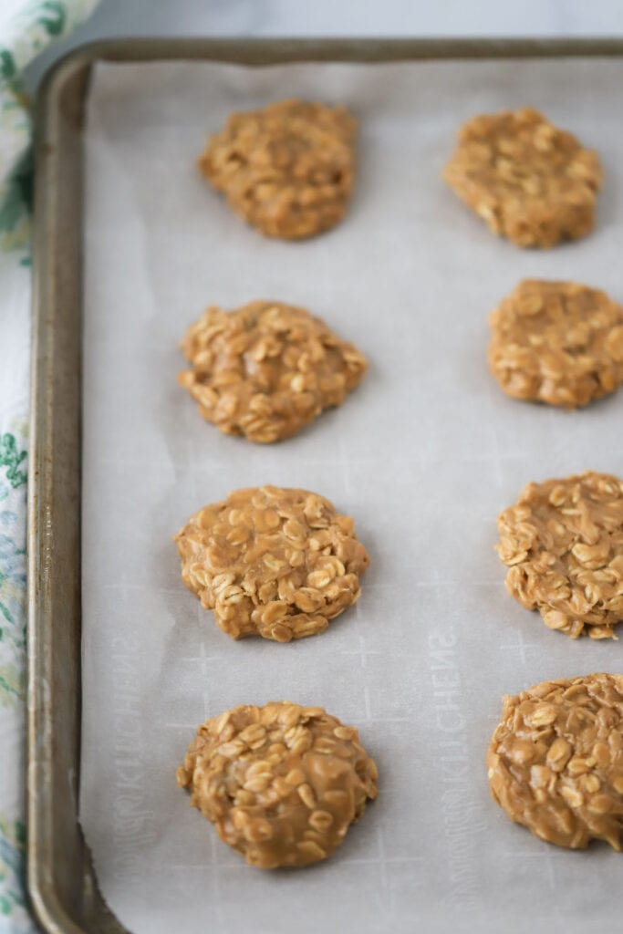 A sheet pan covered with parchment with cookie butter no bake cookies.