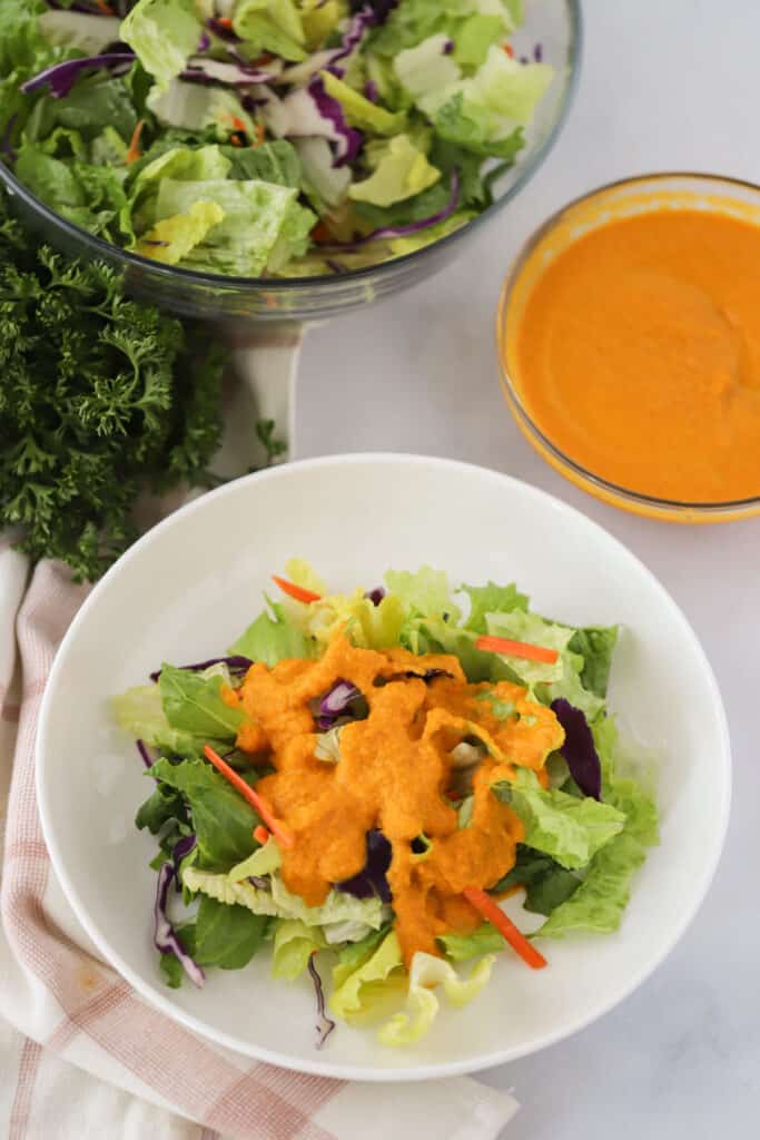 Japanese Carrot ginger salad dressing recipe, tossed with a big bowl of iceberg lettuce. This is a common hibachi ginger dressing.