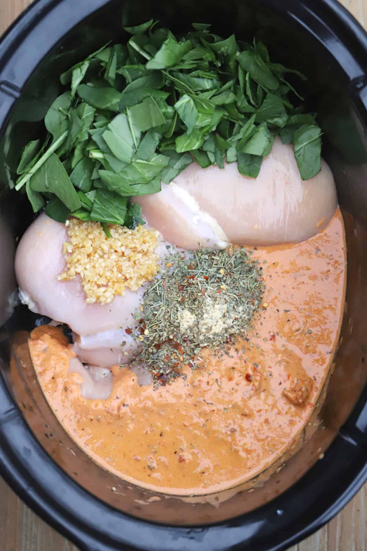 Slow Cooker Tuscan Chicken (Marry Me Chicken) ingredients in a crockpot