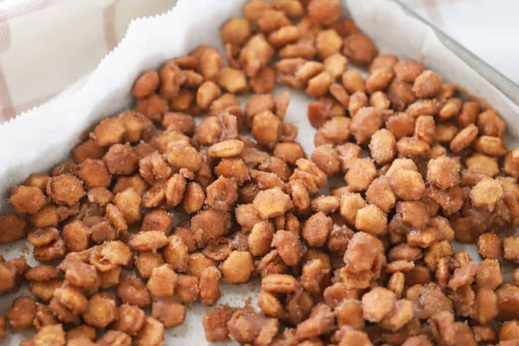 Churro oyster crackers cooling on a sheet tray.