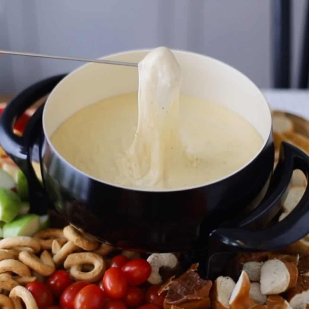Cheese fondue in a fondue pot, one of the best valentines menu ideas.