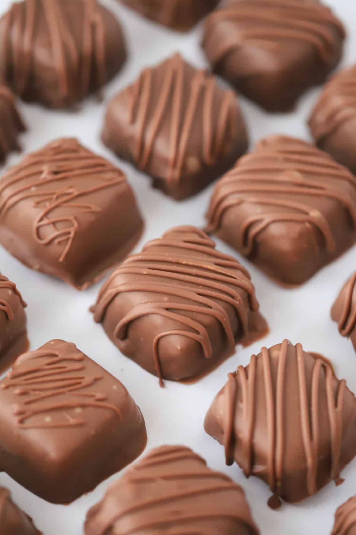 Homemade reeses peanut butter cups lined up on a baking sheet.