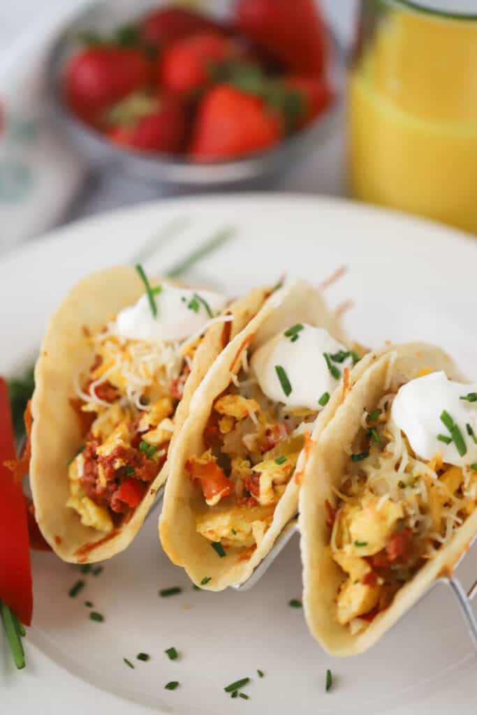 Southwest Breakfast Tacos with chorizo, eggs, potatoes, and sour cream in a taco holder.
