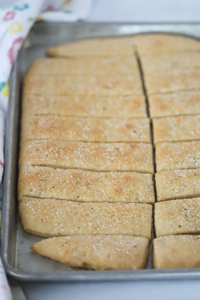 A pan of this whole wheat breadstick recipe on a baking sheet cut into rectangles.