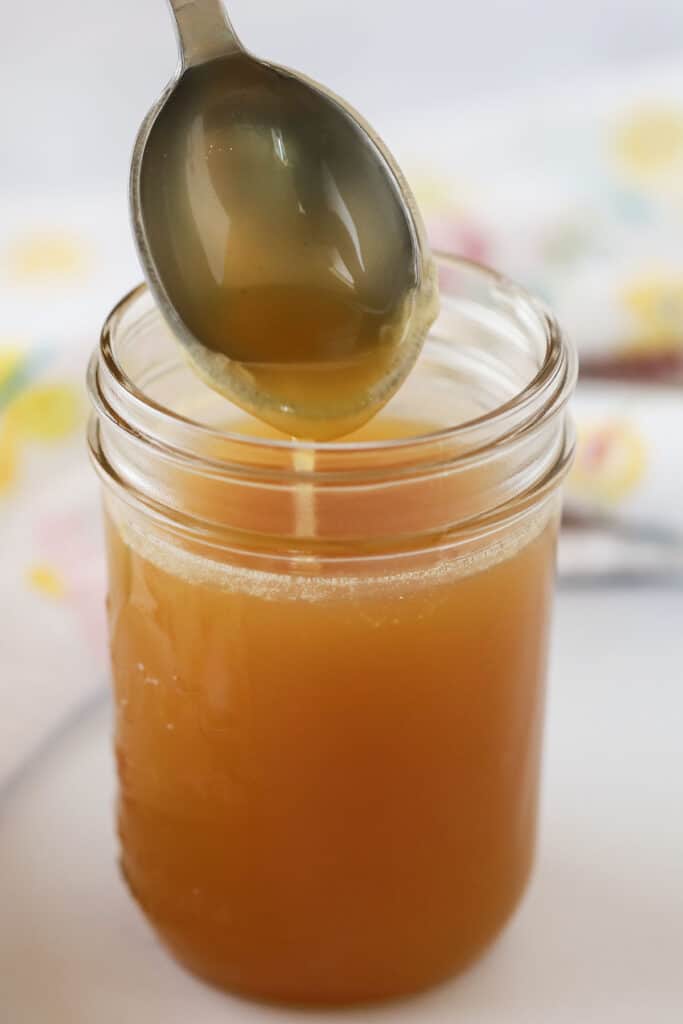 Buttery and sweet recipe for coconut syrup in a small mason jar.