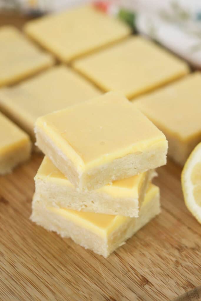 Homemade lemon blondies cut into squares and topped with lemon icing.