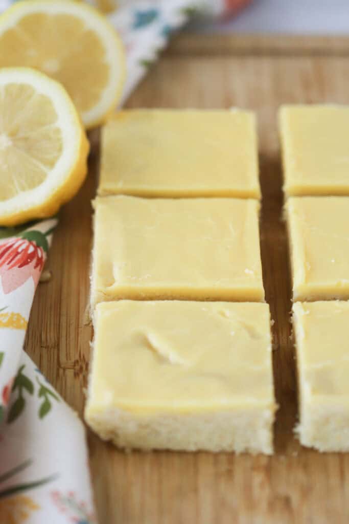 A cutting board with squares of lemon fudge brownies.