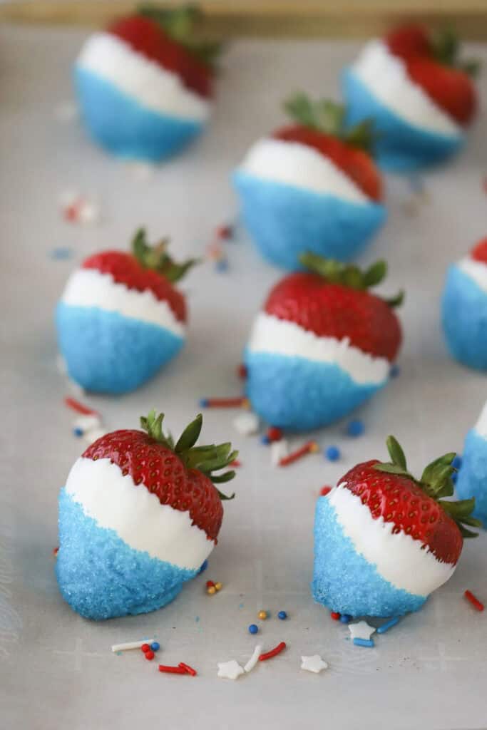 Red white and blue strawberries on a tray cooling.