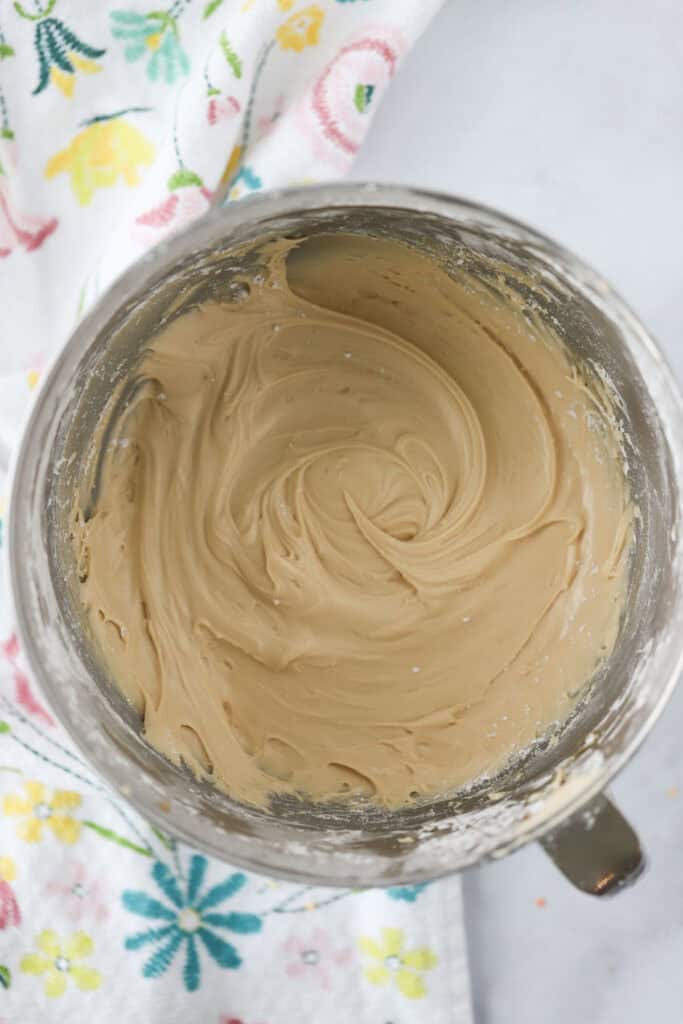 A mixing bowl full of salted caramel icing.