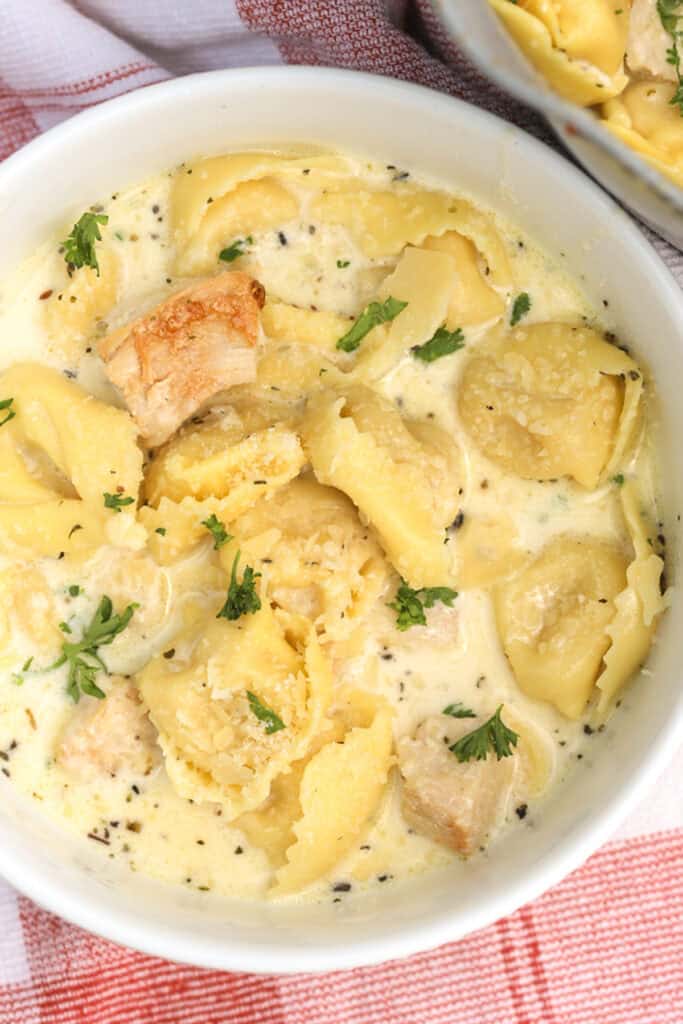 one bite of tortellini pasta, in the recipe for chicken tortelloni alfredo, alfredo tortellini. 