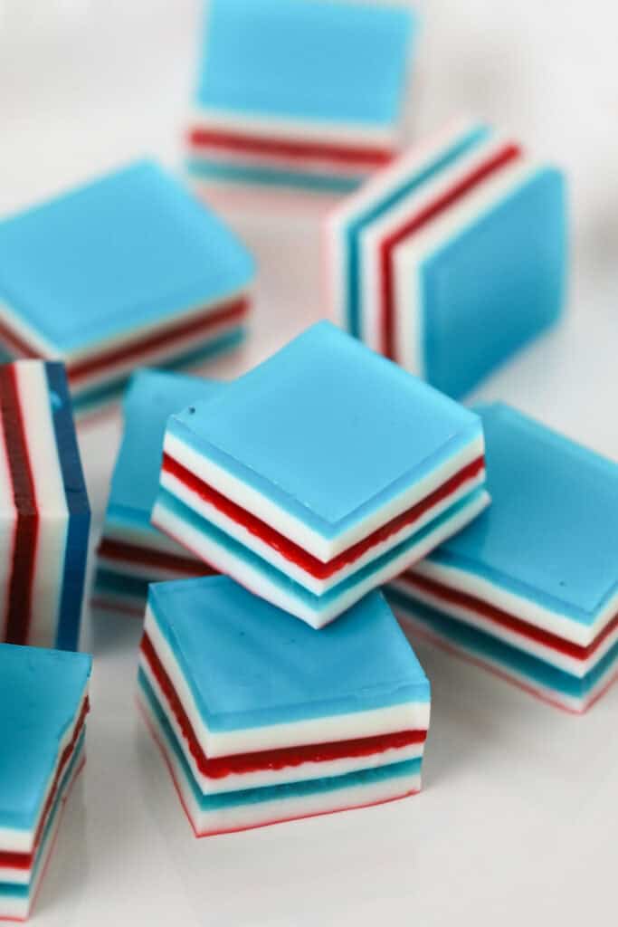 Thin layers of red white and blue Jello  cut into cubes for the 4th of July.