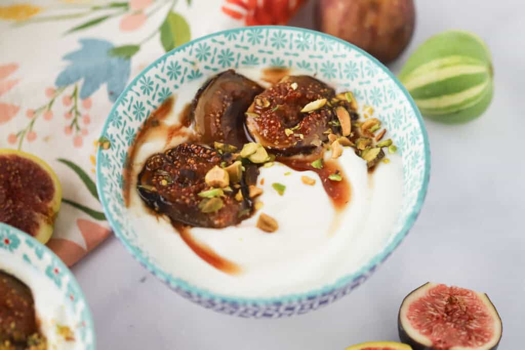 A small bowl with caramelized figs served over honey.