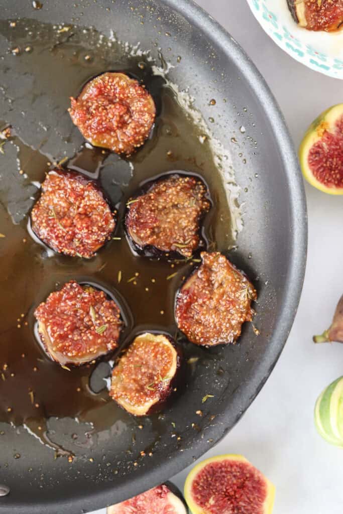 A saute pan with caramelized figs in honey.