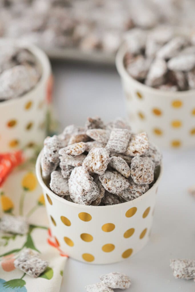 Nutella Muddy Buddies in small party cups on a tabletop.