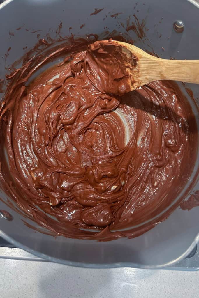 A large bowl full of melted chocolate and peanut butter.