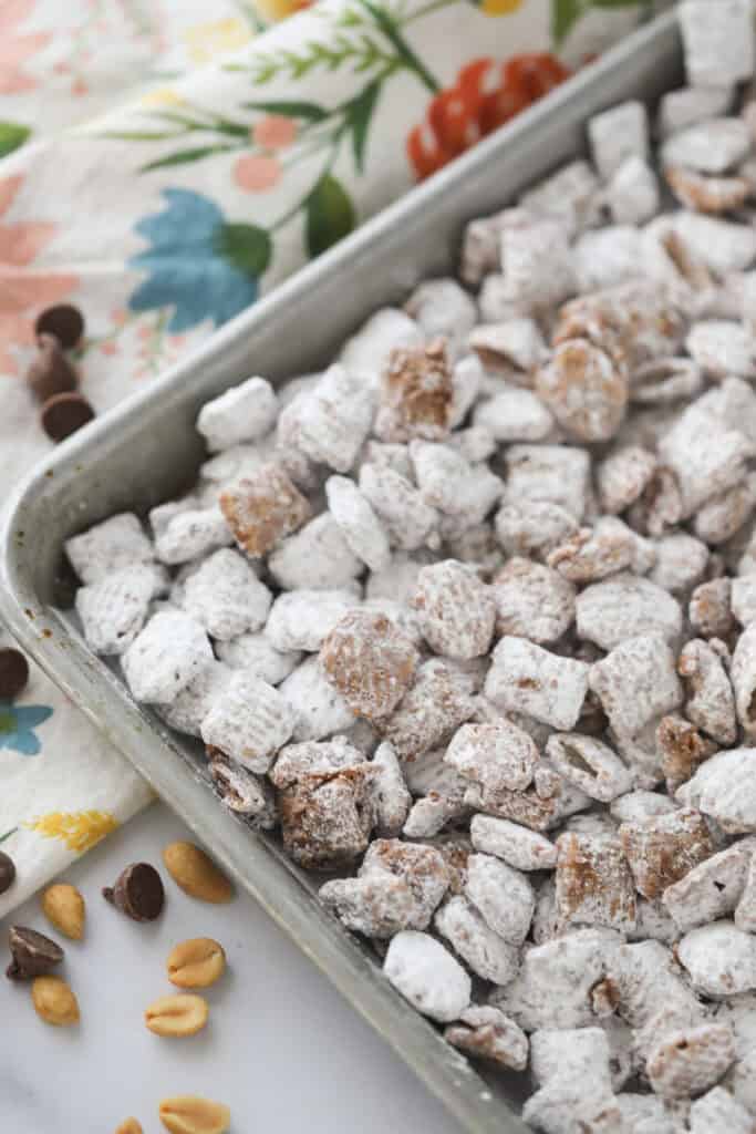 A baking sheet full of chocolate peanut butter muddy buddies.