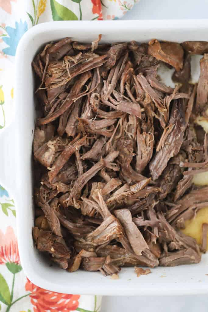 Chuck roast in a baking dish to be used for French Dip sandwiches.