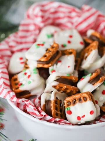 A bowl full of rolo candy and pretzel treats.